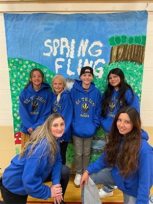 group of students in front of sign that says Spring Fling